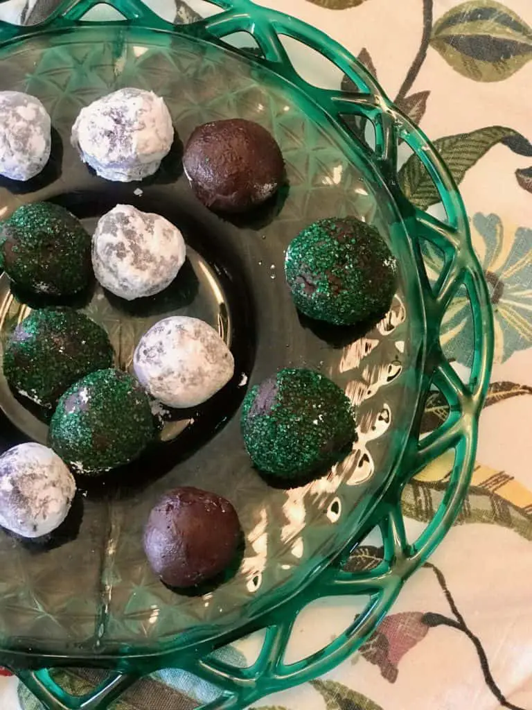 Chocolate and peppermint truffles on a green plate.