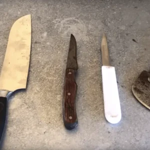 Five different knives on a countertop.