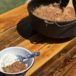 A bowl of food with a cast iron pot.