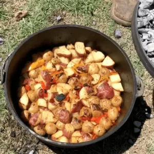 Potatoes and peppers cooking in a Dutch oven.