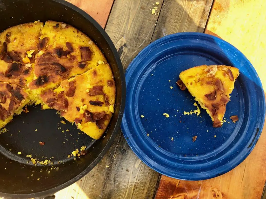 A plate of cornbread with bacon bits.