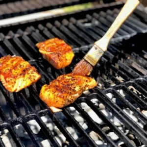 Salmon fillets grilling on a barbecue.