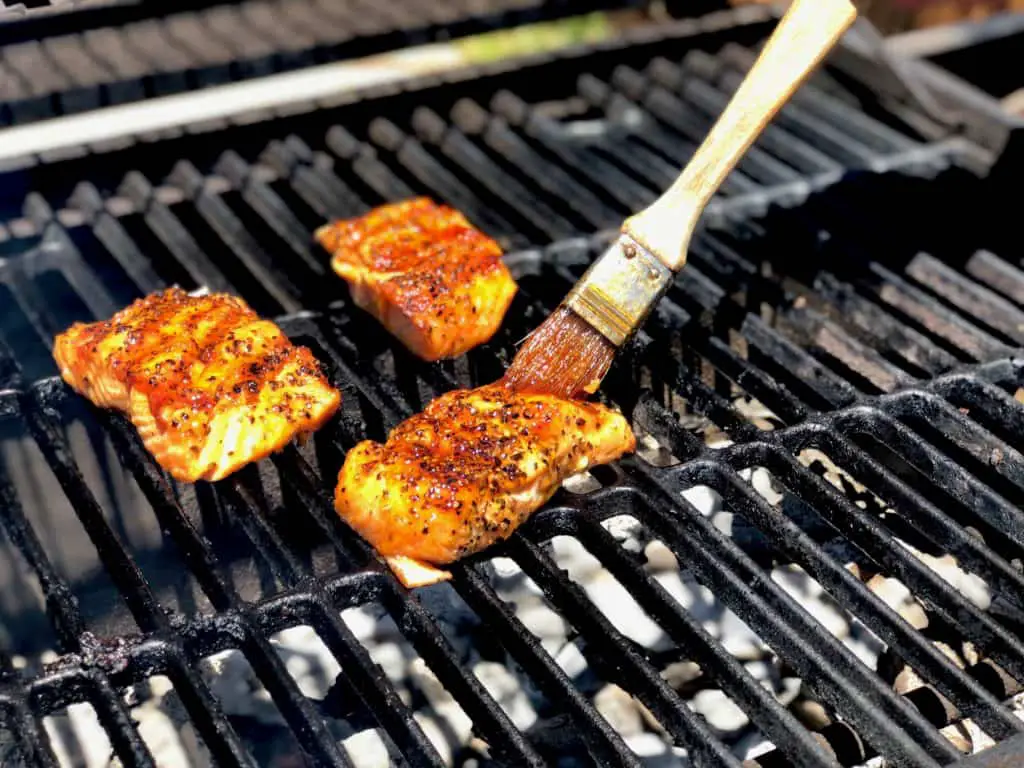 Salmon fillets grilling on a barbecue.