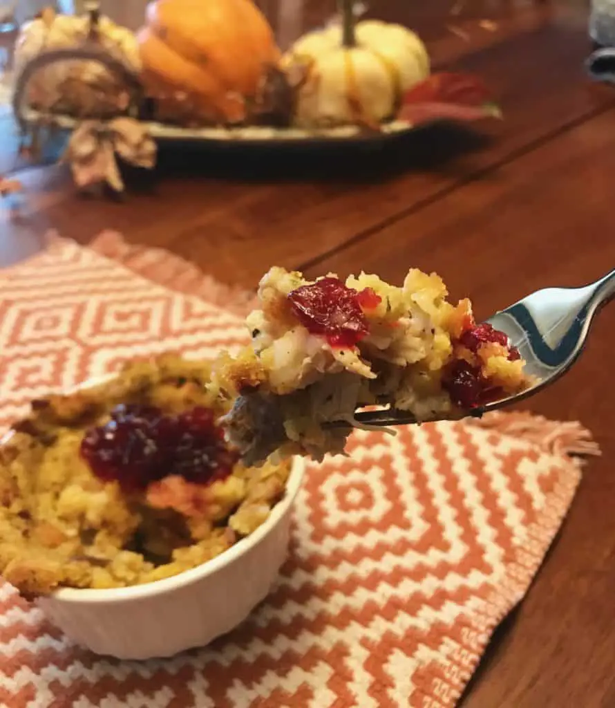 Forkful of stuffing with cranberry sauce.