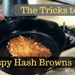 Crispy hash browns cooking in a pan.