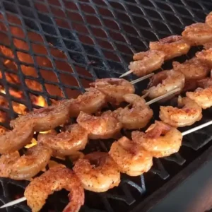 Grilled shrimp skewers on a hot grill.