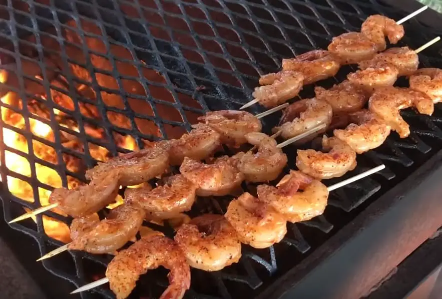 Grilled shrimp skewers on a hot grill.