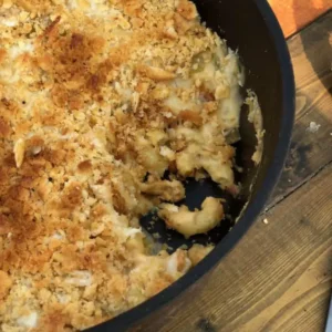 Golden brown mac and cheese casserole in a pan.