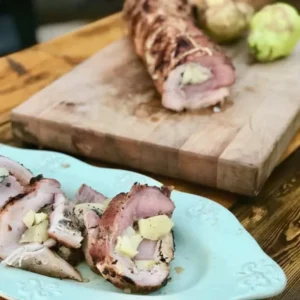 Grilled pork tenderloin stuffed with apples.