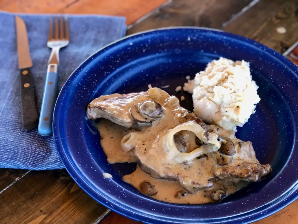 Steak with mushroom gravy and mashed potatoes.