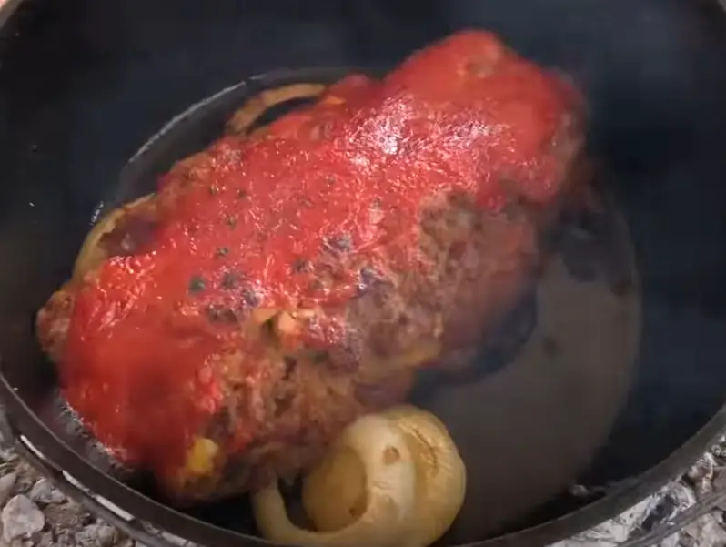 Meatloaf with tomato sauce in a pot.