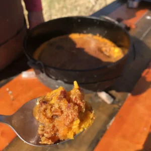 Sweet potato casserole with pecans on a spoon.