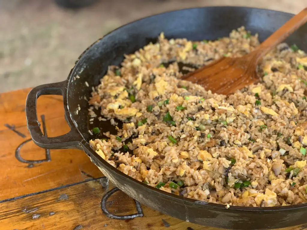 Fried rice with egg and green onions in a cast iron skillet.