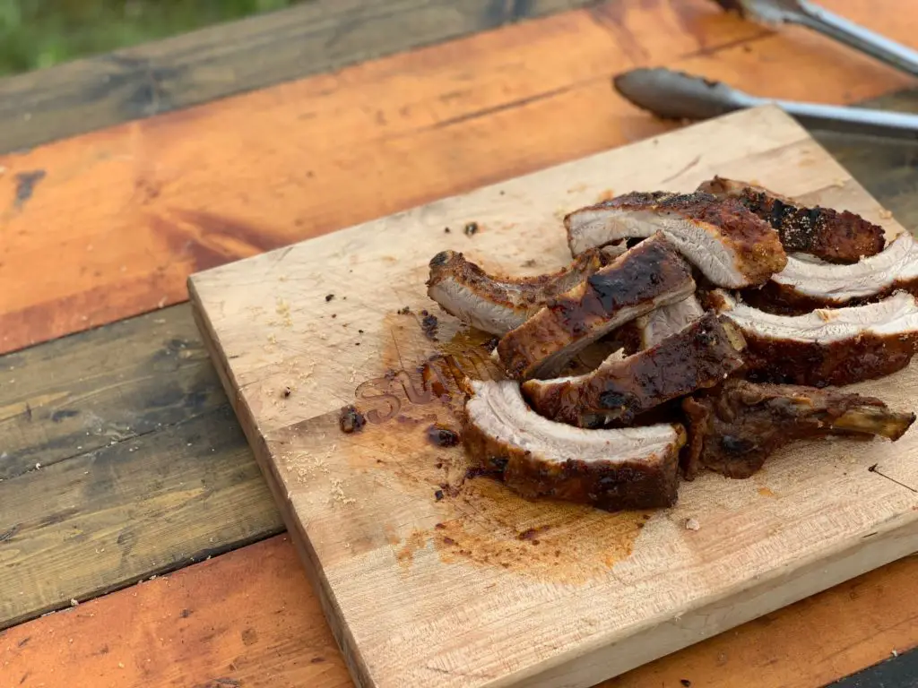 Grilled pork ribs on a wooden board.