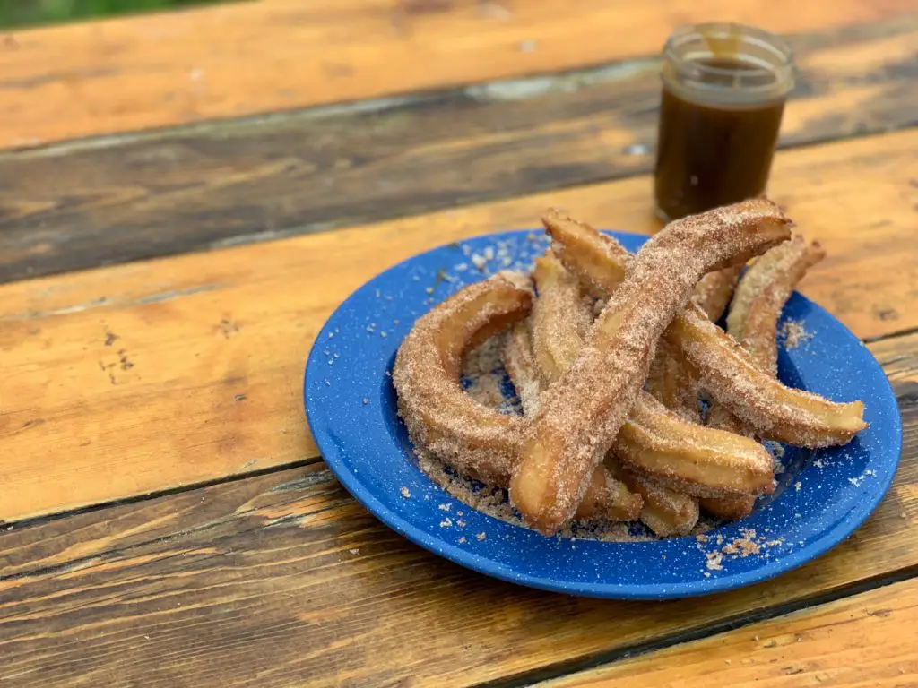 Cinnamon sugar churros on a blue plate.