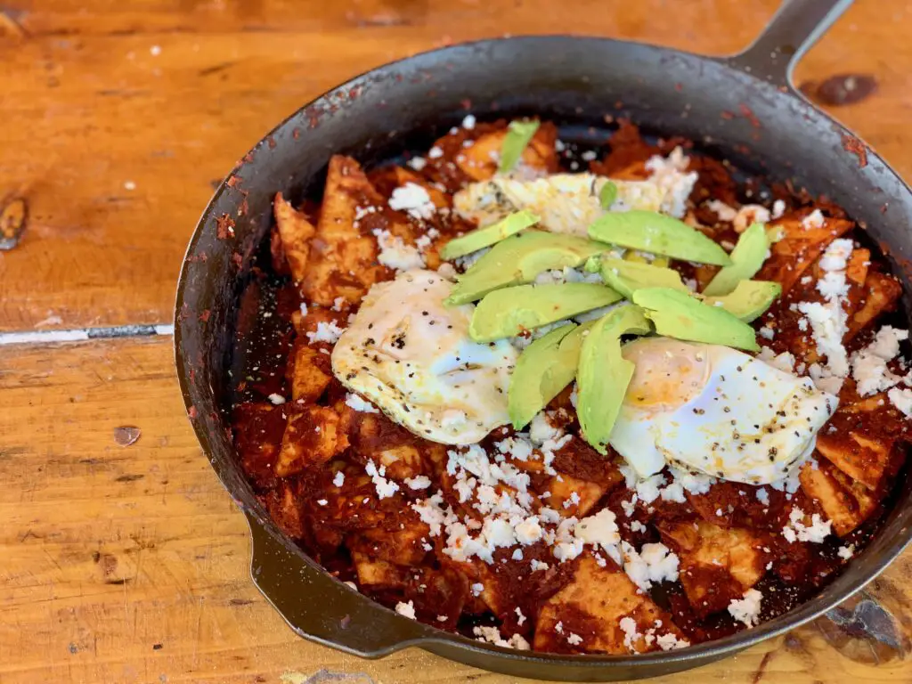 Chilaquiles with eggs, avocado, and cheese.