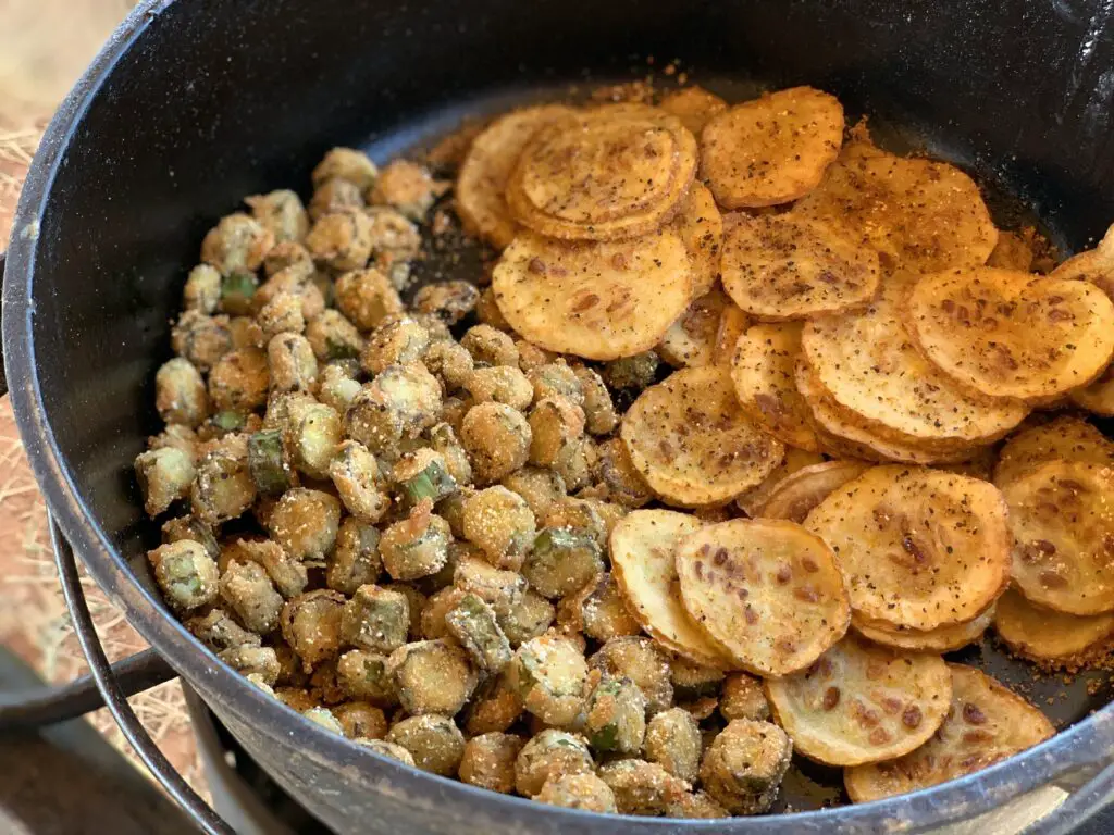 Fried okra and potato chips in a cast iron pot.