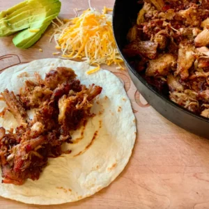 Pulled pork taco filling with avocado and cheese.