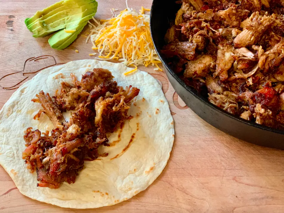 Pulled pork taco filling with avocado and cheese.