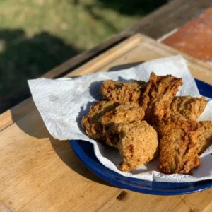 Fried fish on a blue plate and paper towel.