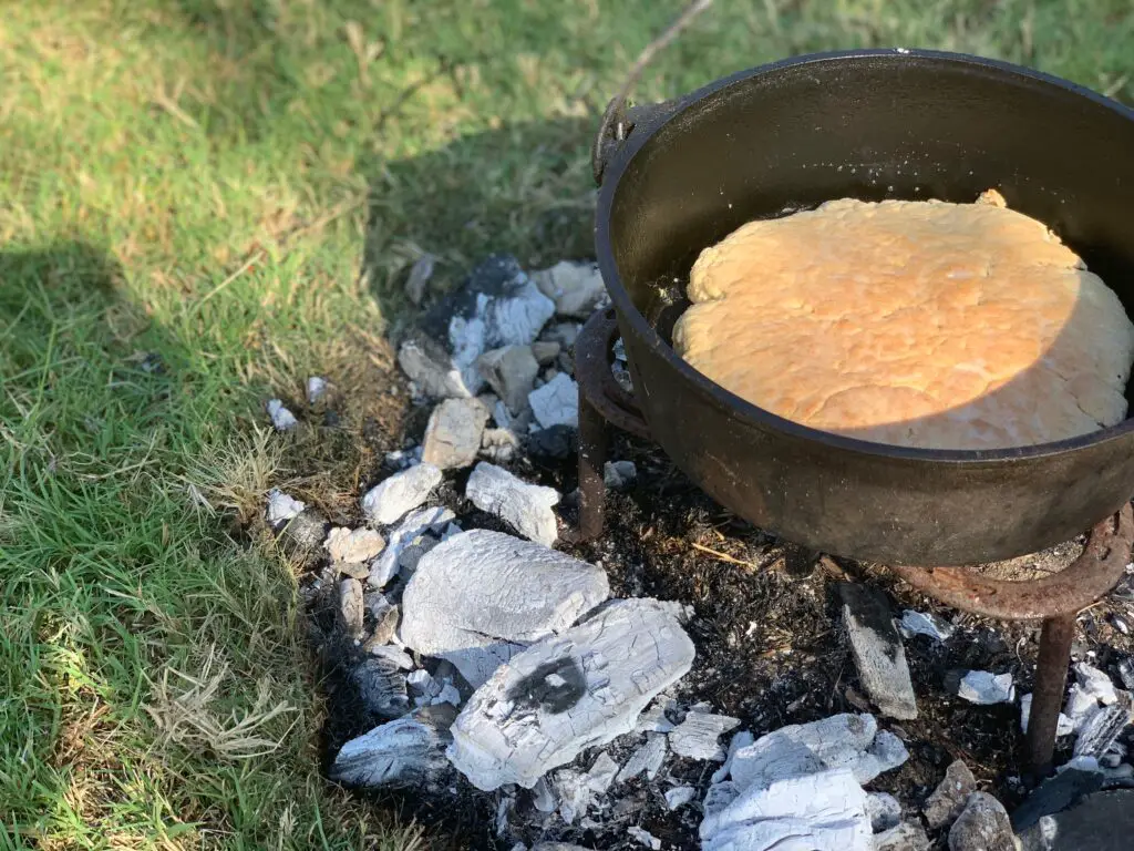 Dutch oven bread baking on coals.