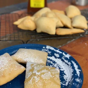 Powdered sugar and honey on fried bread.