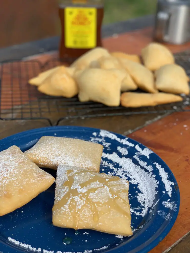 Powdered sugar and honey on fried bread.