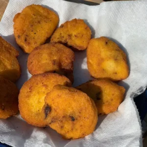 Fried cornbread on a paper towel.