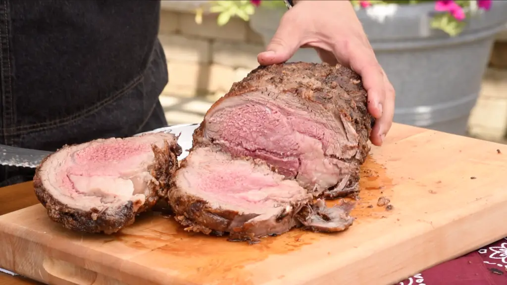 Sliced roasted beef on cutting board.