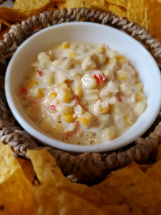 Corn and crab dip with tortilla chips.