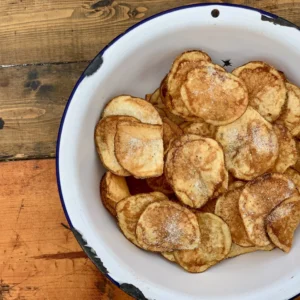 A bowl of food on top of a wooden table.