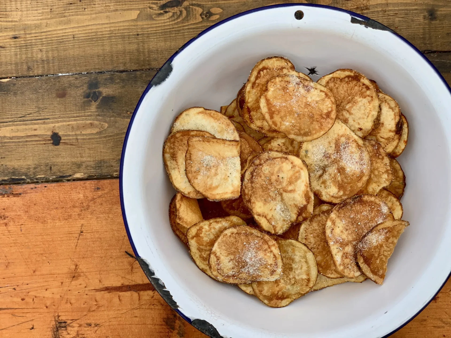 A bowl of food on top of a wooden table.