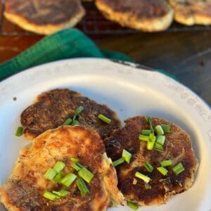 Three fried potato cakes with green onions.