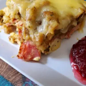 Cheesy baked dish with cranberry sauce.