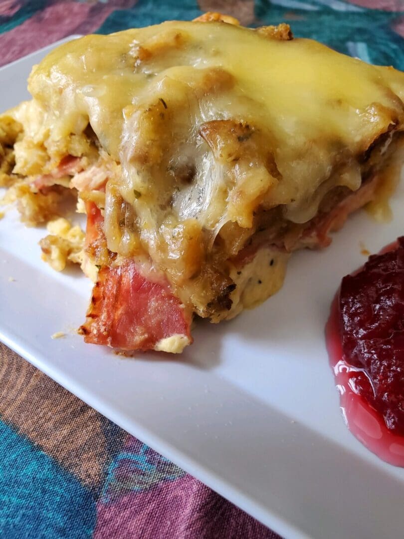 Cheesy baked dish with cranberry sauce.