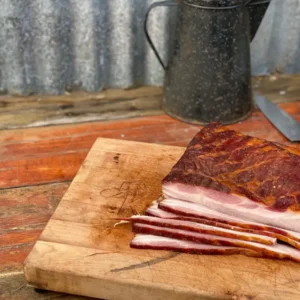 Smoked bacon slices on a wooden board.