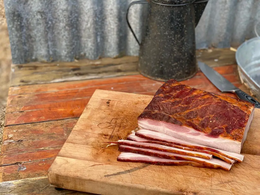 Smoked bacon slices on a wooden board.