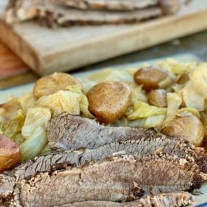 Sliced corned beef with cabbage and potatoes.