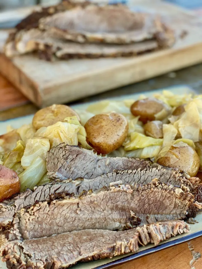 Sliced corned beef with cabbage and potatoes.