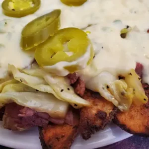 Potato skins with cheese, jalapenos, and sauce.