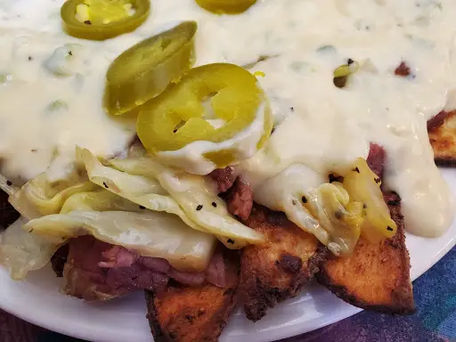 Potato skins with cheese, jalapenos, and sauce.