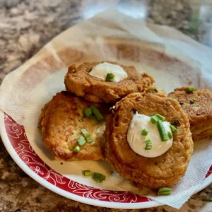 Fried potato cakes with sour cream and chives.