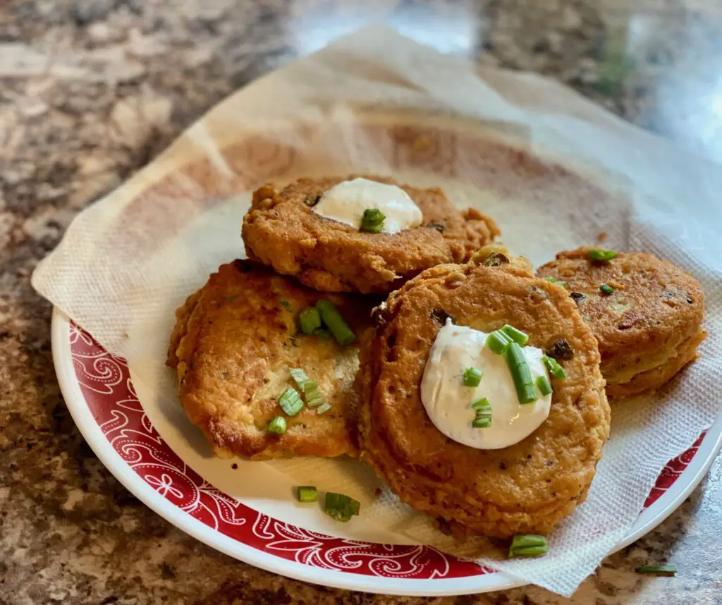 Fried potato cakes with sour cream and chives.