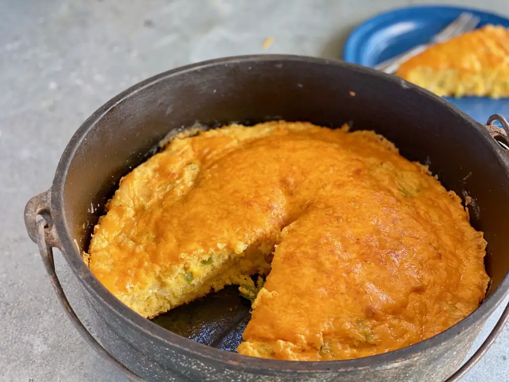 Cheesy cornbread baked in a Dutch oven.