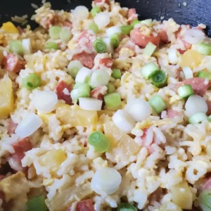 Fried rice with pineapple, ham, and green onions.