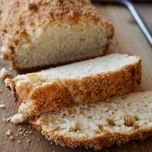 Slices of crumb-topped bread on a board.