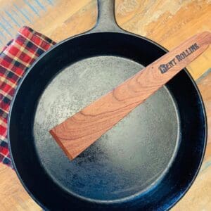 Cast iron skillet with a wooden handle.