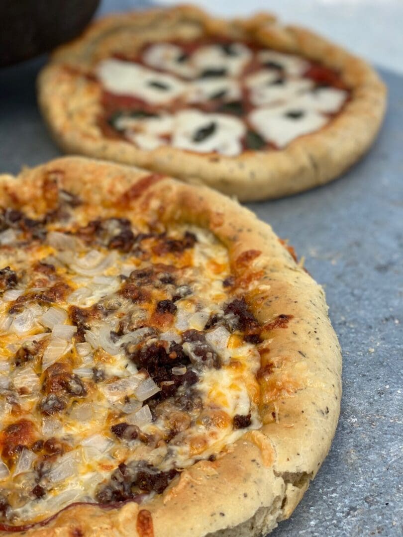 Closeup of a cheesy meat and onion pizza.