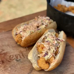 Fried shrimp po'boys with slaw and sauce.