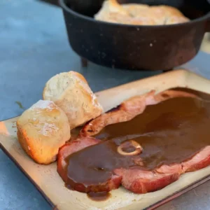 A plate of food with meat and bread on it.